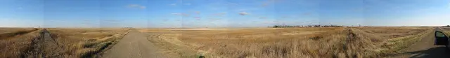 Flat prairie panorama with gravel roads